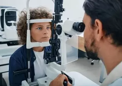 Woman getting an eye exam by doctor