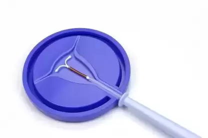 Paragard IUD in a blue dish against a white background