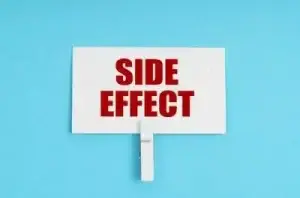 Side effect in red on white sign against a teal background