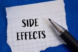 Side effects words written on ripped white paper with blue background. Conceptual side effects symbol. Copy space.