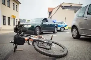 Nashville bicycle accident with bike laying over on street with three cares behind looking at bicycle accident