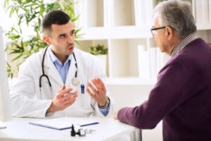 Man who was a victim of a surgical error talks to another doctor to see if he should call a Nashville surgical error lawyer,