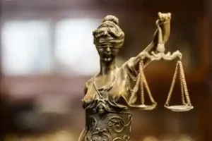 lady justice in gold looking forward