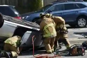 Firemen try and rescue women Involved in a head-on collision in Nashville and car rolled over