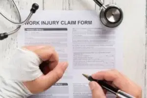 Man filling form when injured at work to get workers' compensation in Tennessee