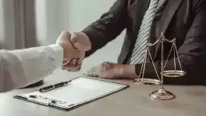 Nashville car wreck lawyer shakes hands with client who was injured in a car wreck in Nashville