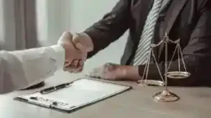 Nashville distracted driver accident lawyer shakes hands with client who was in a car wreck caused by a distracted driver