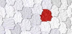 red face surrounded by a bunch of white faces