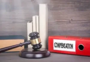 Compensation. Wooden gavel and books in background. Law and justice concept