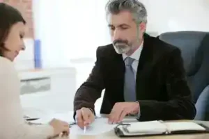 Nolensville Social Security Disability Lawyer meets with female client about social security benefits while going over notes