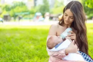 Mother feeding baby after successful recovery from being a victim of maternity negligence