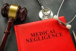 Red medical negligence book illustrative of the $120 birth injury verdict in two separate cases representing two of the Largest Birth Injury Settlements in U.S. History,