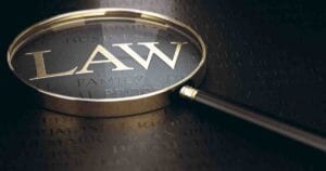 Word law written in golden letters over black background and magnifying glass. 3d illustration for DoubleVerify Class Action Lawsuit
