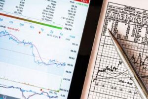 white stock chart with pen next to it