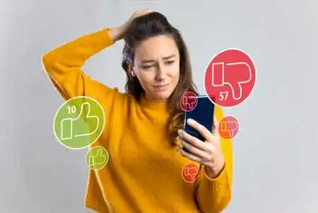 Young girl on social medial on phone with thumbs up and down logos used in class actin lawsuit