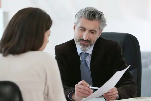 lawyer meeting with client at desk about Securities Class Action Lawsuits