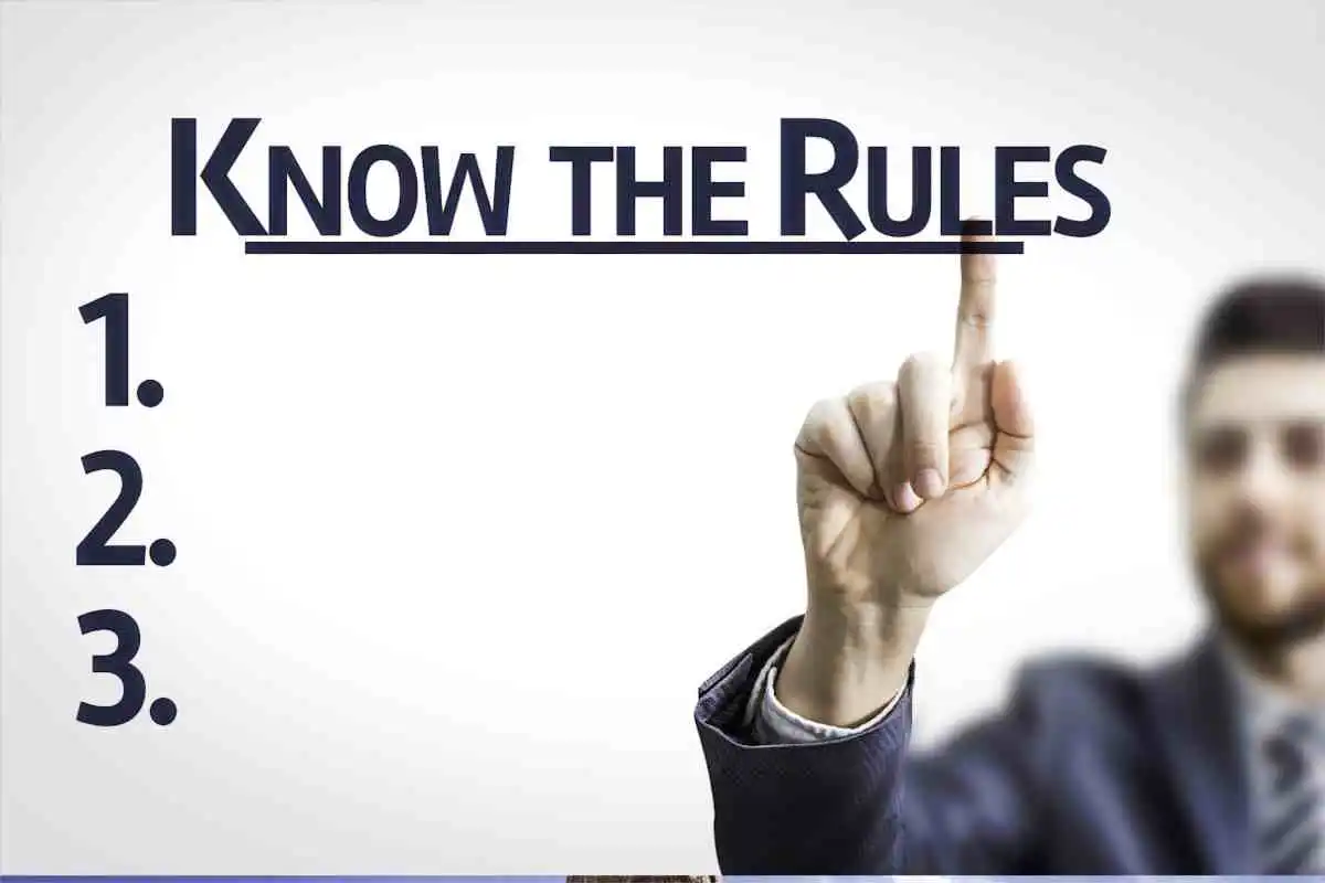 Man pointing finger to words on mirror "Know the Rules" used in Employee Training on Code of Conduct
