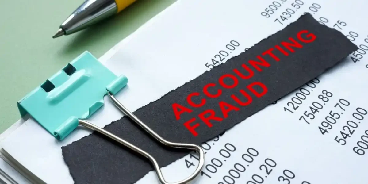 accounting fraud in red on black background used in improper financial reporting