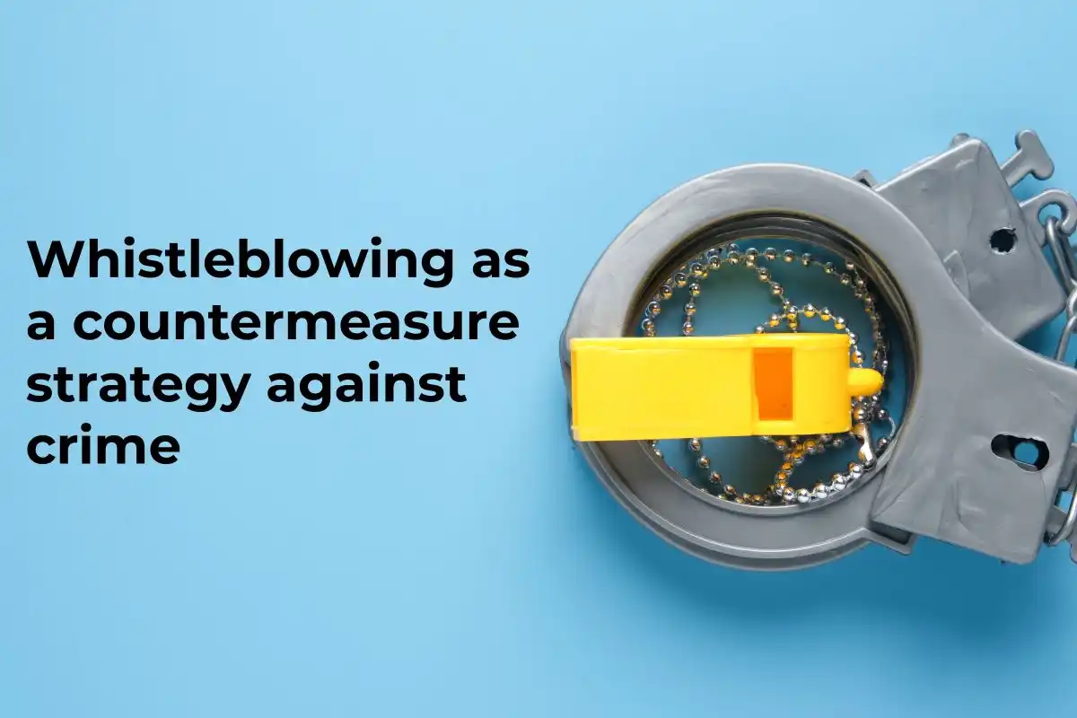 A picture of toy handcuff and whistle with the word whistleblowing as a countermeasure strategy against crime. used in Whistleblower Protections in Financial Reporting 