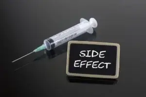Medical Concept: Side Effect with syringe on blackboard used in Dupixent Cancer Lawsuit