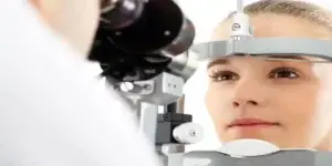 YOUNG WOMEN GETTNG EYE EXAM USED IN Mounjaro and NAION