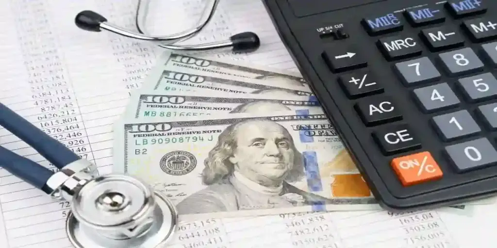 Stethoscope over dollars, calculator and papers. Banking business. Financial analysis concept. used in Dupixent Cancer Lawsuit