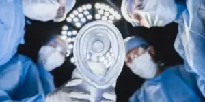 doctors in blue scrubs at operating table looking at patient and used in Catastrophic Injury Attorney in Nashville