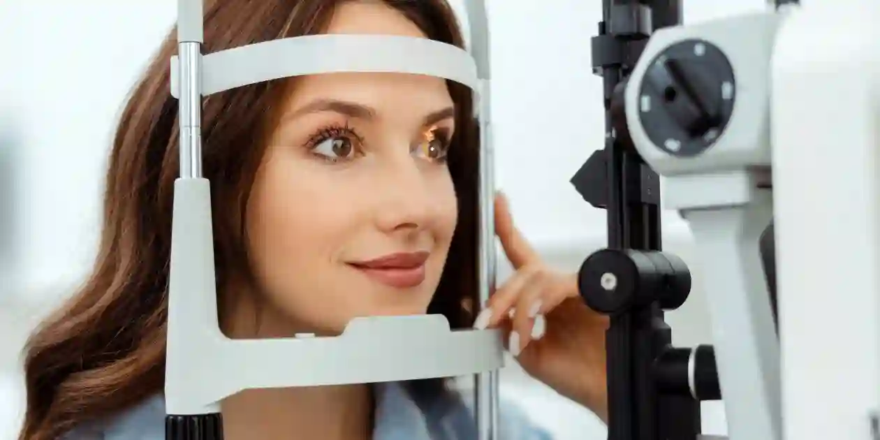 Smiling young lady examining her eyes with slit lamp in optical store. used in Mounjaro Stomach Paralysis Lawsuit