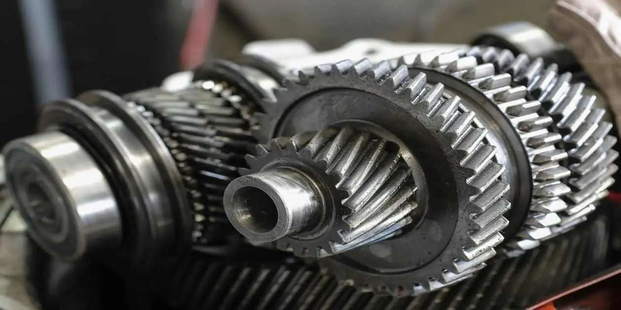 Brand new silver transmission on display on a table used in Broken GM Transmission Issues