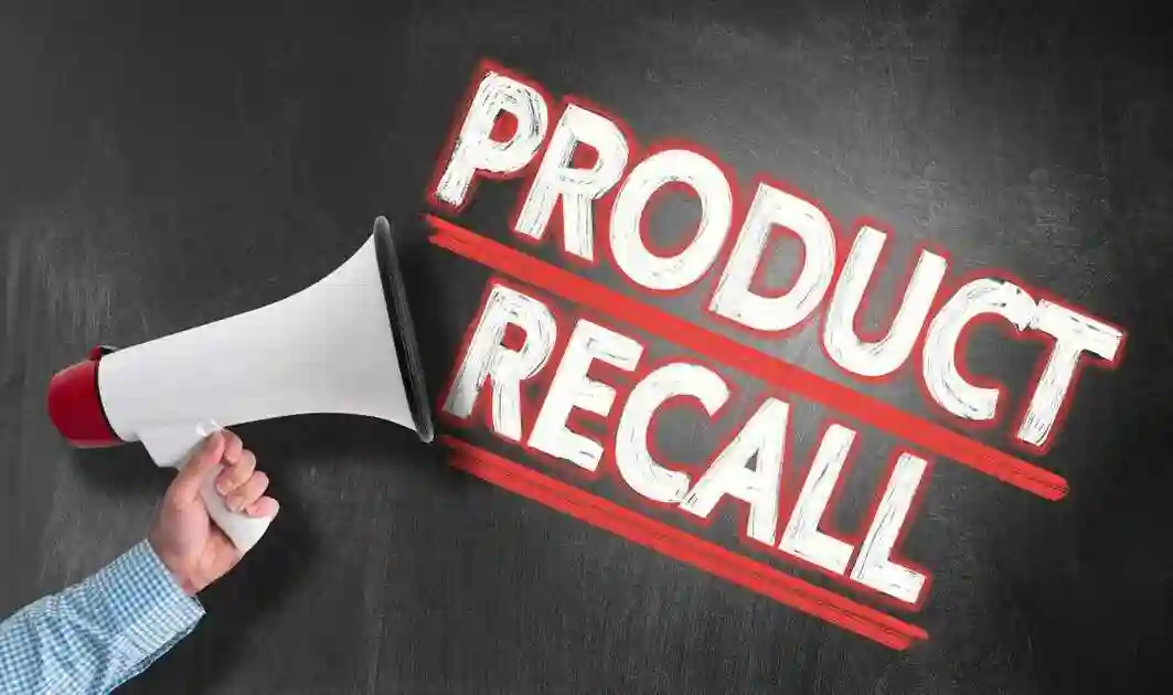 Hand holding megaphone or bullhorn against blackboard with text PRODUCT RECALL
used in Faulty GM Transmission