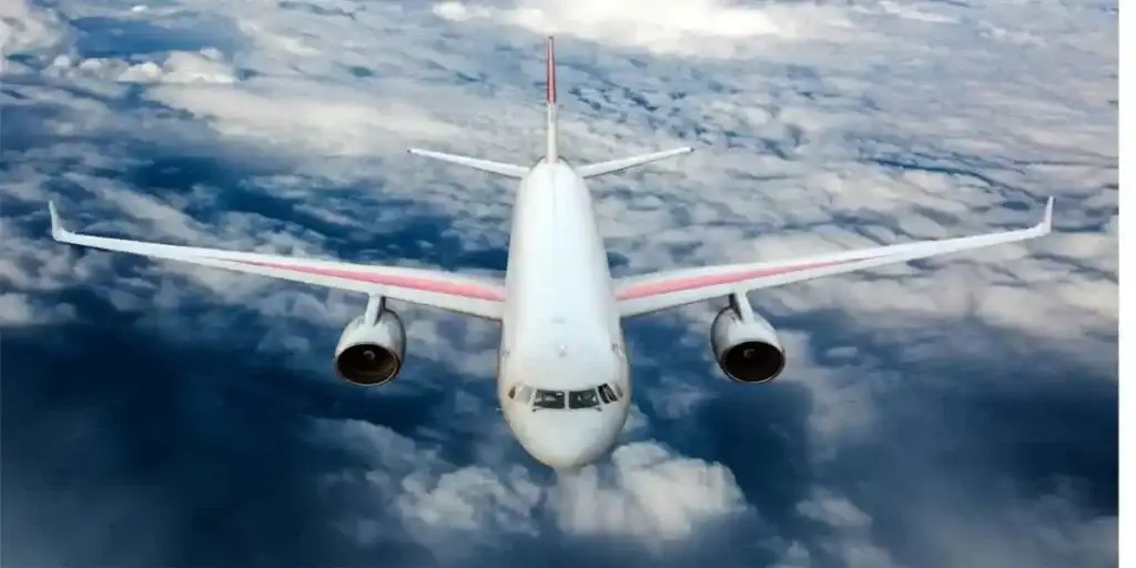 Passenger airplane in midflight, flying over clouds in day, used in fume even lawsuits