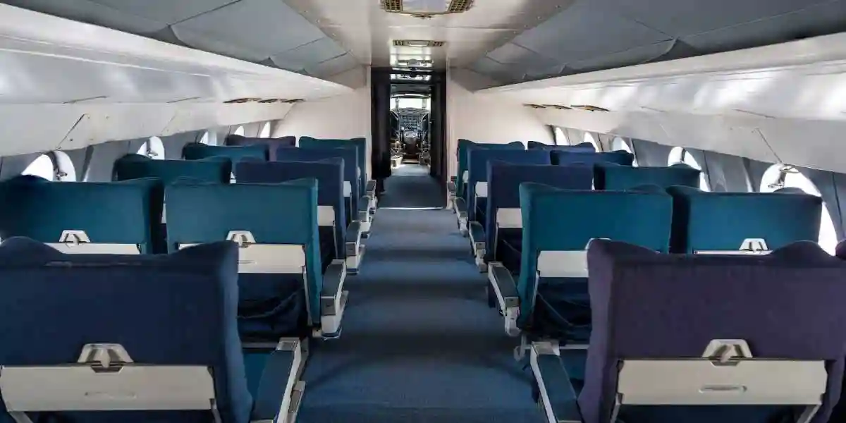 Emply airplane cabin prior to take off with green seats and a green aisle used in Toxic Cabin Fumes
