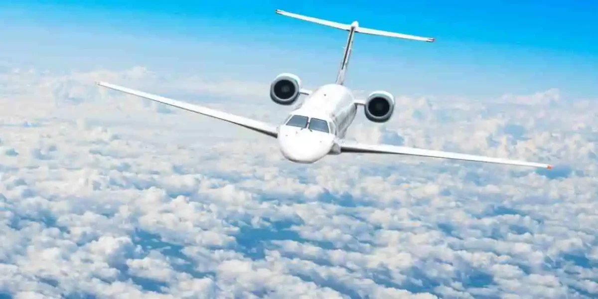 whitye passenger plane flying above clouds on beautiful day used in Fume Event Lawsuits