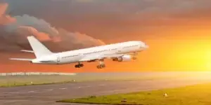 large passenger flying about the clouds and dusk with sun in front and very beautiful