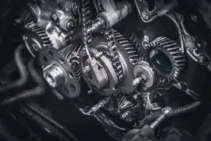 Mechanic in work gloves repairs car engine in auto repair shop. Auto mechanic checks vehicle with wrench, fixes issues. Car service, maintenance, engine diagnostic, automotive repair. used in GM Transmission Lawyer