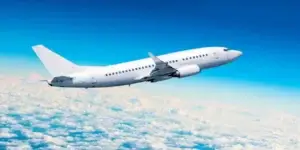 Passenger plane flying about eh clouds in a blue ski and beautiful day used in Eligible for a Toxic Fumes Exposure Lawsuit