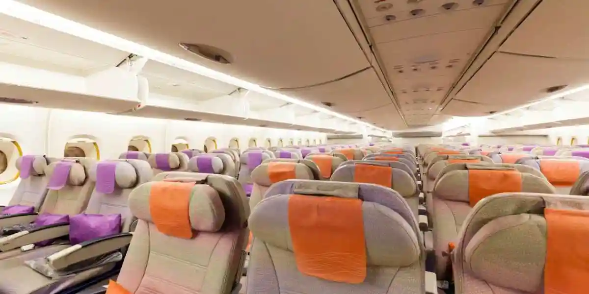 empty plane  cabin with tan seats used in exposure to toxic plane fumes