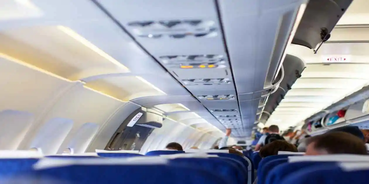 inside of passenger airline jet blue and white seats passengres putting lugage us in Symptoms of Contaminated Cabin Air 