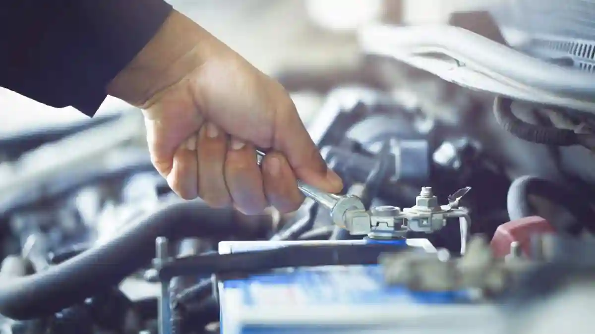 Mechanic in work gloves repairs car engine in auto repair shop. Auto mechanic checks vehicle with wrench, fixes issues. Car service, maintenance, engine diagnostic, automotive repair. used in Qualify for a qualifying defective GM transmission issues