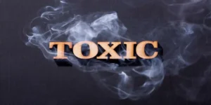 Toxic word in wooden letters with smoke, used in Criteria for an Toxic Fume Exposure
