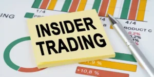 Business concept. On the business charts are a pen and stickers with the inscription - insider trading used in Pinterest class action lawsuit