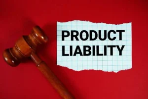 Product Liability text written on rip paper with wooden judgment gavel on red background used in Defective Medical Products Update