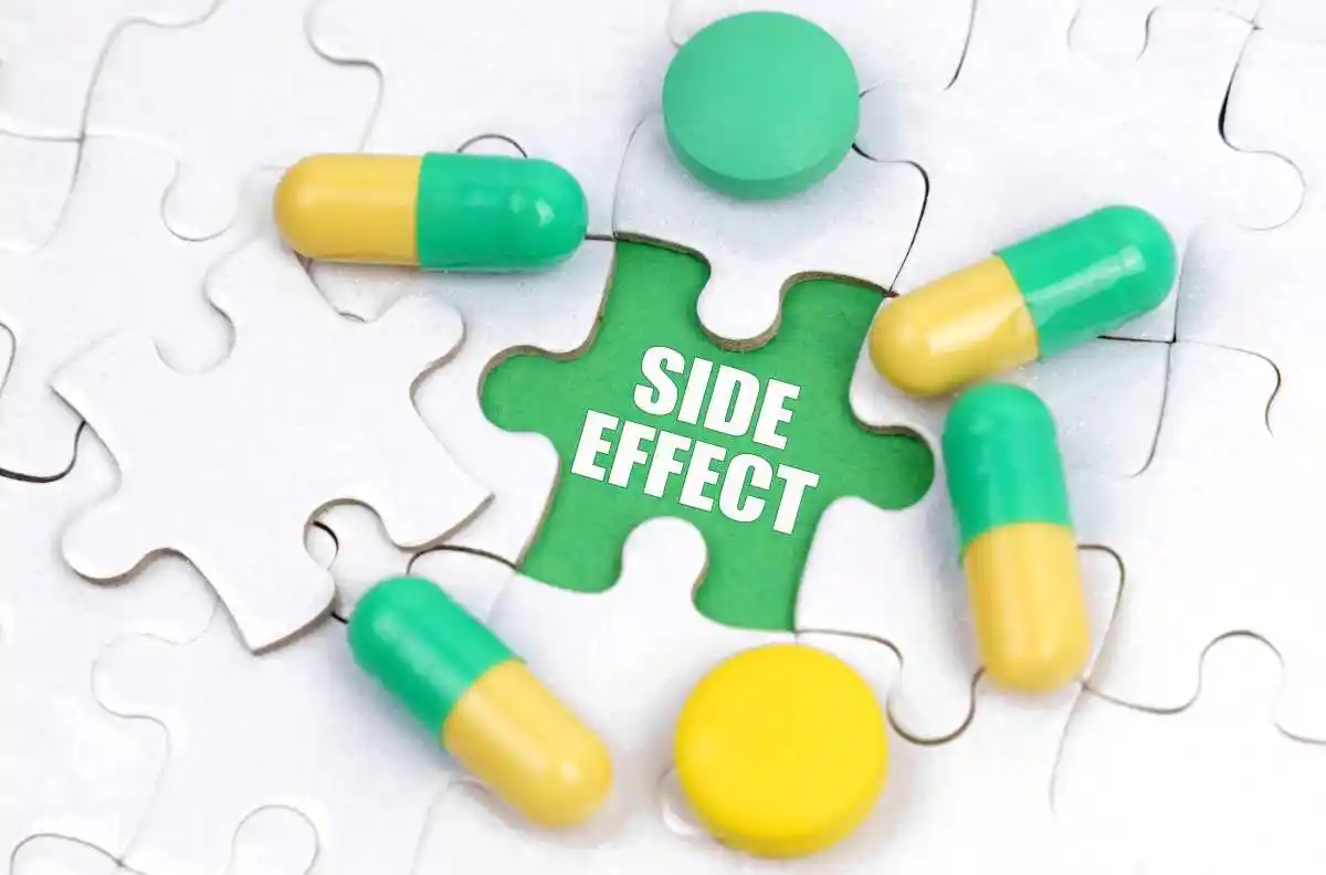 Medicine concept. There are pills and vitamins on the white puzzles. Inside on a green background the inscription - SIDE EFFECT 