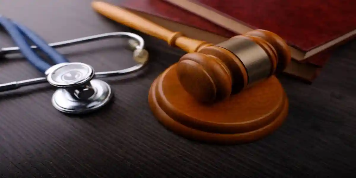 Gavel and stethoscope on wooden background, symbol photo for bungling and medical error. Medicine laws and legal, medical jurisprudence.