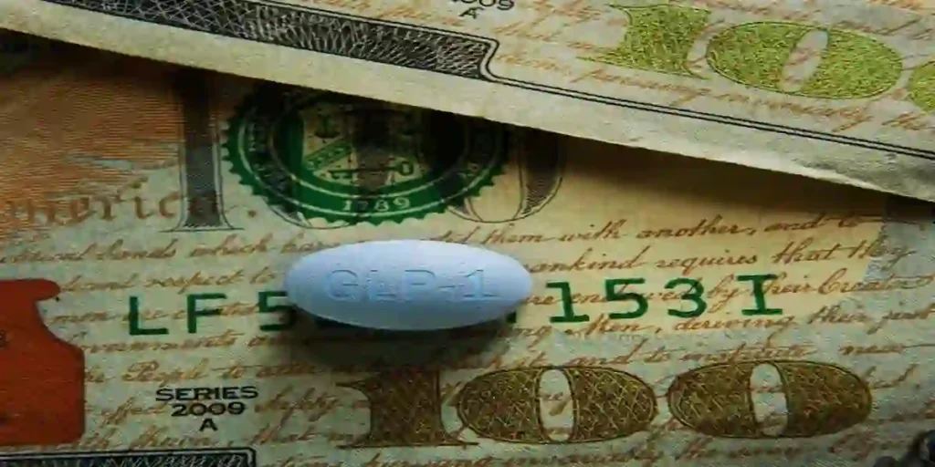 A GLP-1 pill on US hundred dollar bills