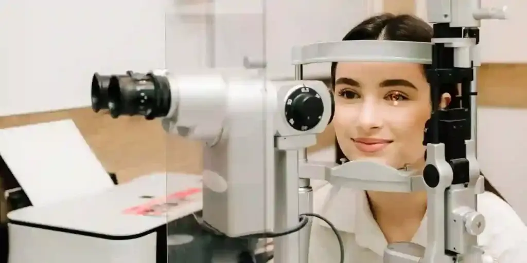 Ophthalmologist with slit lamp examines eyes and cornea of woman. Ophthalmologist illuminates eye of patient with light from slit lamp to diagnose the eyes and cornea and used in Trulicity Blindness