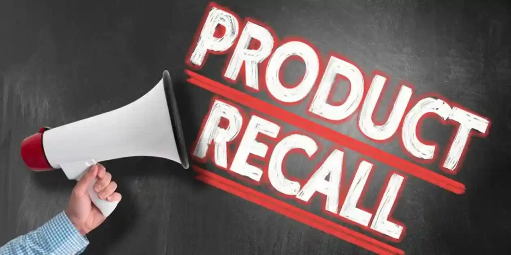 hand holding megaphone or bullhorn against blackboard with text PRODUCT RECALL and used in Dexcom Device Recall