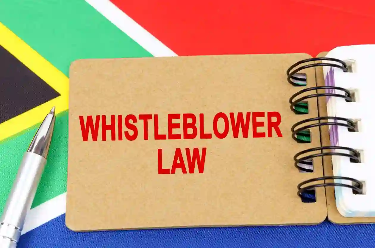 Law and justice concept. Against the background of the flag of South Africa lies a notebook with the inscription - WHISTLEBLOWER LAW used in nashville whistleblower lawyre