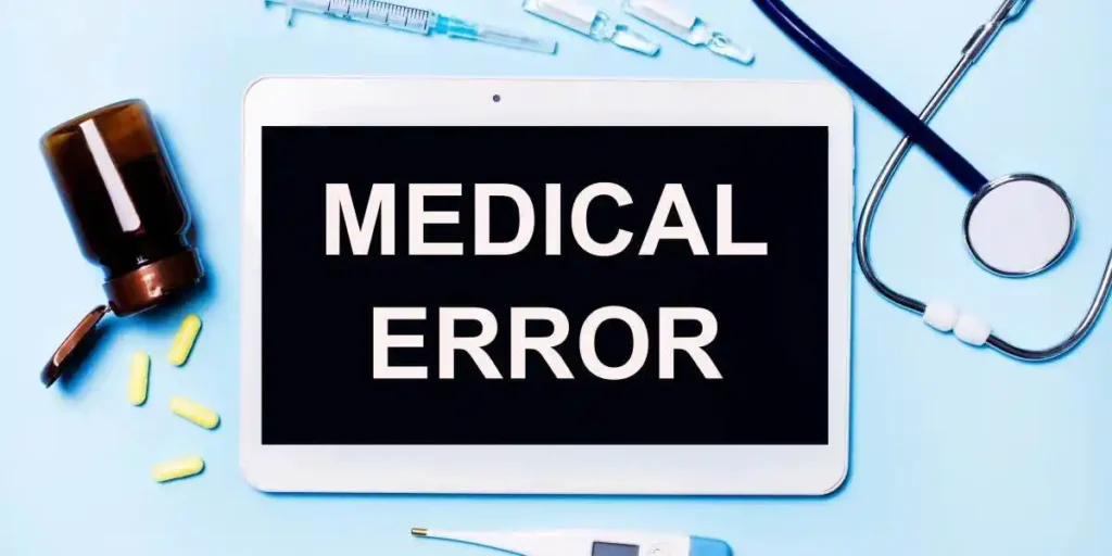Ampoules, pills, stethoscope, thermometer, tablet with MEDICAL ERROR text on desktop. Medical diagnosis or doctor's prescription mockup. Medicine concept used in pharmacy Injury Lawyer in Nashville
