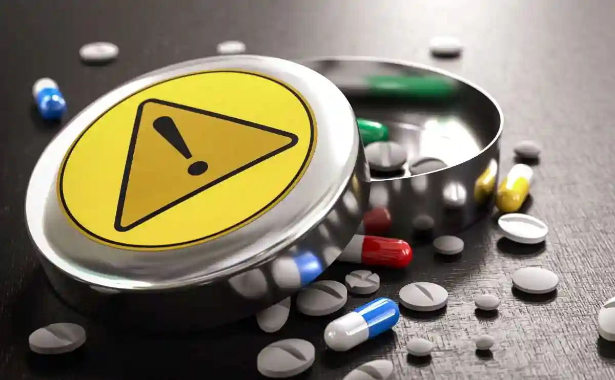 Box of different pills and tablets with warning sign. Drug interactions and risks or adverse effects concept. 3D render
used in Compensation For a Pharmacy Medication Error